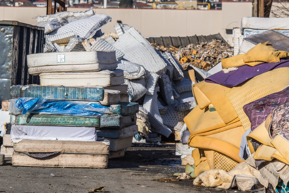 Multiple mattresses stacked on top of one another at a landfill site after people figured out it was an easy way to get rid of old mattresses