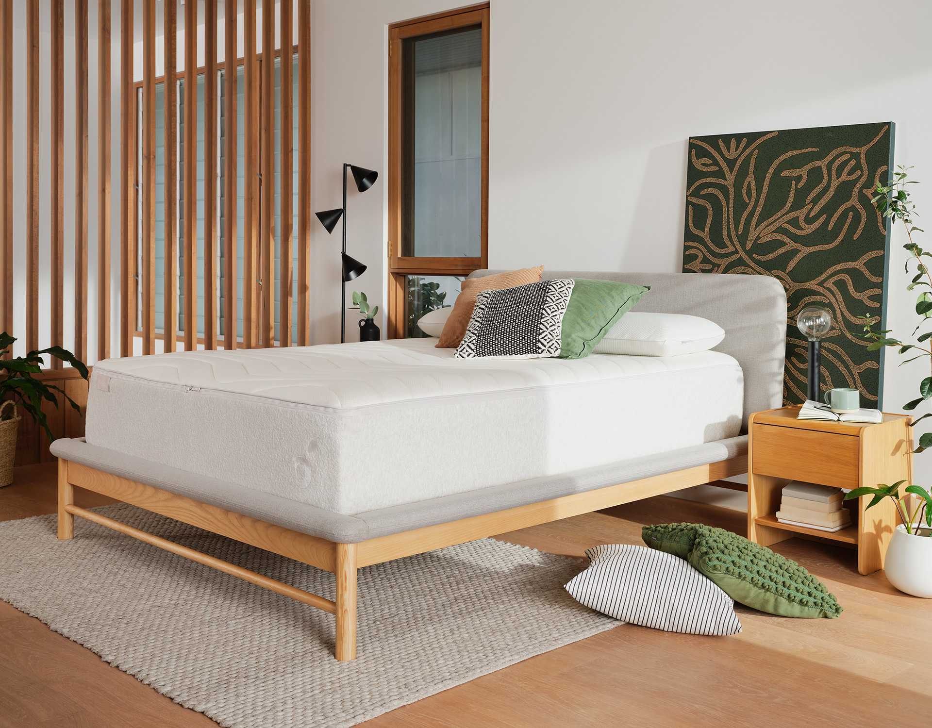 One of the best mattresses for heavier people in Australia, this supportive Koala mattress is dressed with cushions in a bright room