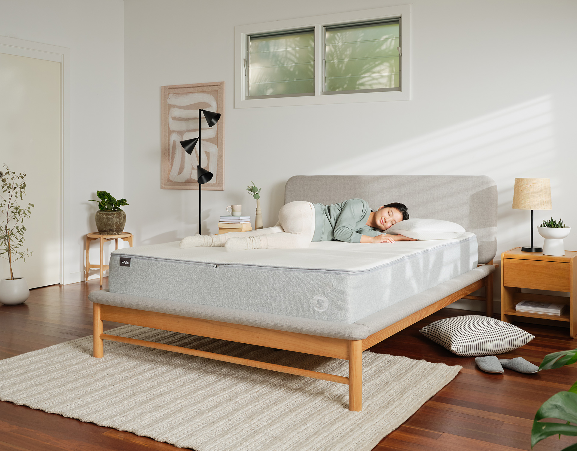 Woman sleeping comfortably on her Koala mattress, which is one of the best mattresses for side sleepers in Australia