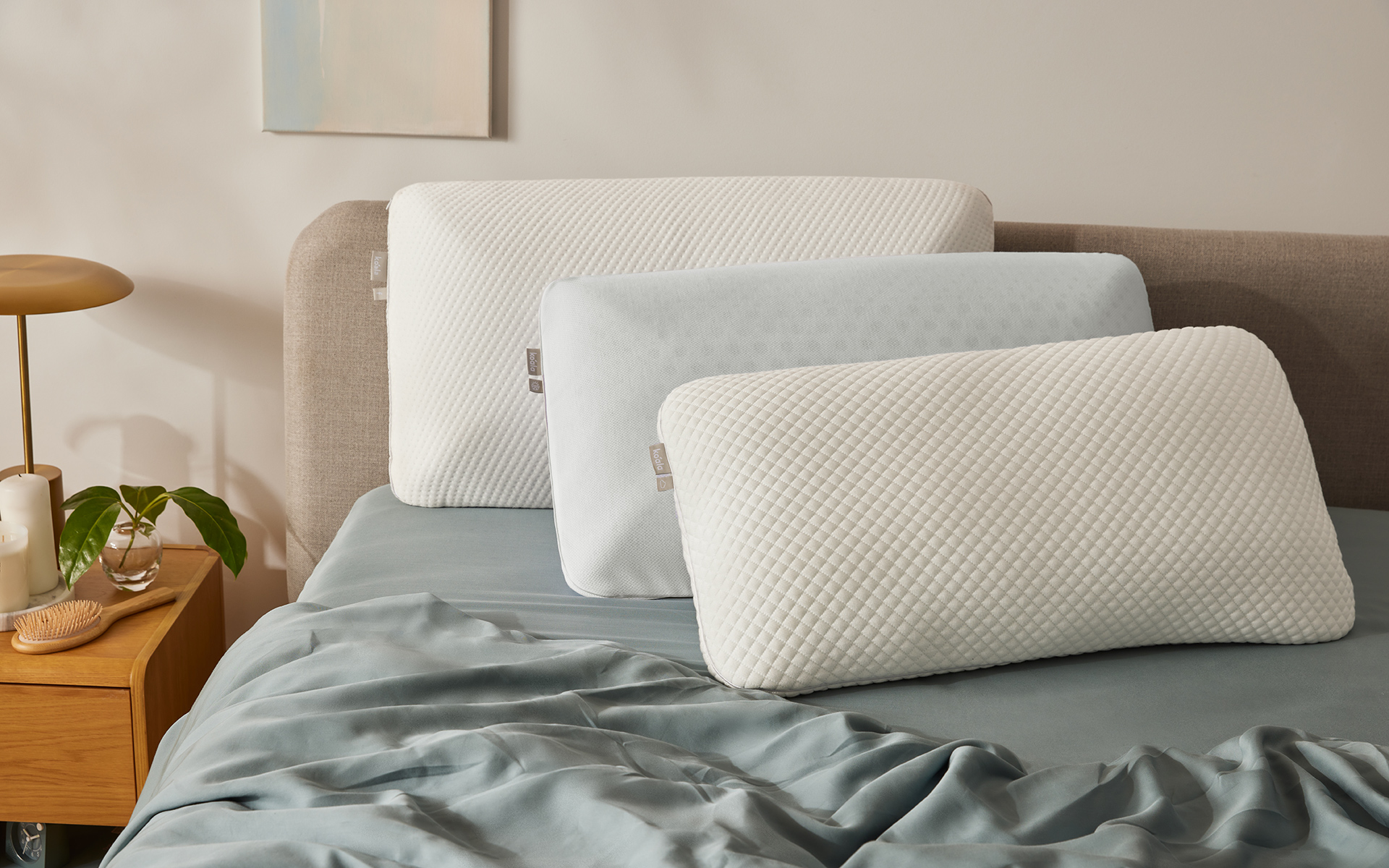 For sleepers searching for the best pillow for a sore neck, these three Koala pillows, pictured on a bed with Koala Tencel sheets, are a great choice