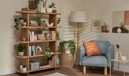great example of boho furniture is the Koala bookshelf with armchair, plants and other collectables in a lounge room