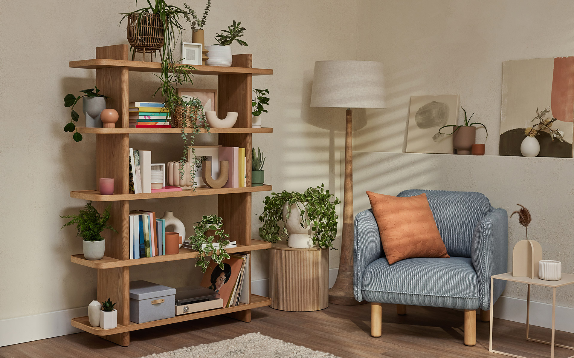 great example of boho furniture is the Koala bookshelf with armchair, plants and other collectables in a lounge room