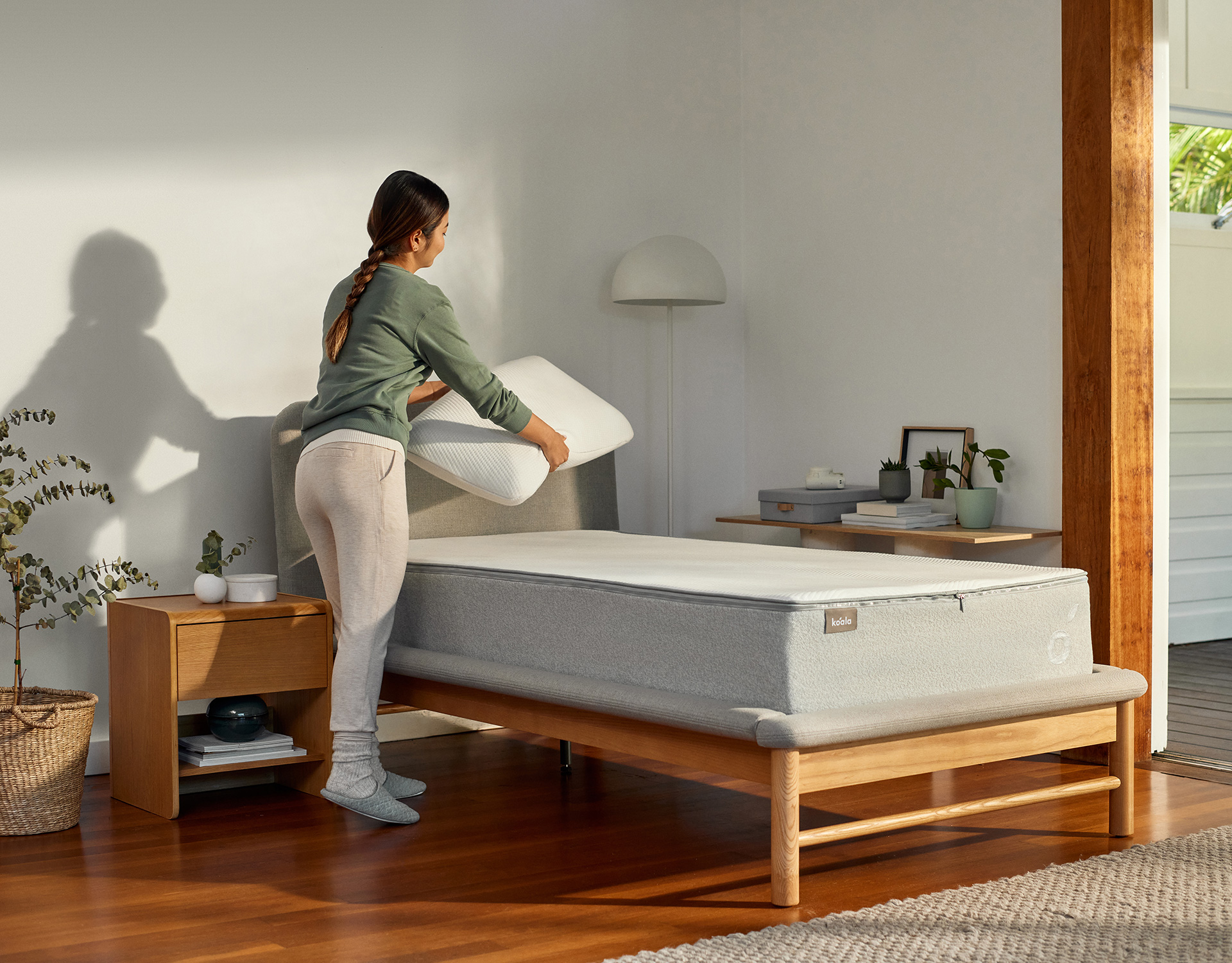 A young woman prepares to enjoy a great night’s sleep on her Koala Kloudcell mattress