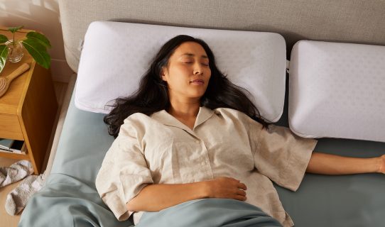 A woman sleeps soundly on her Koala pillow