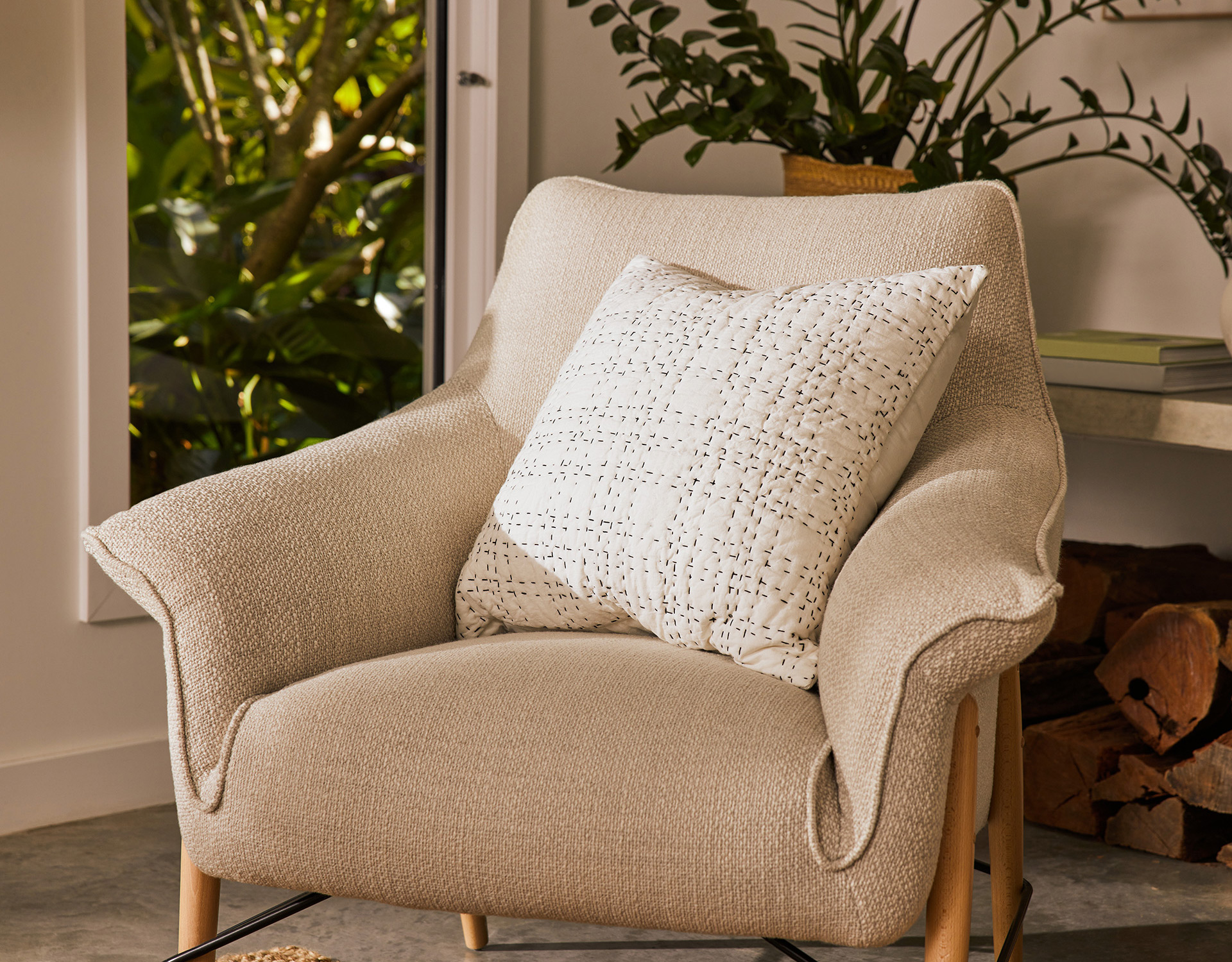 A warm Scandinavian living room is created thanks to clean lines, timber features and quality pieces such as this Koala chair and cushion