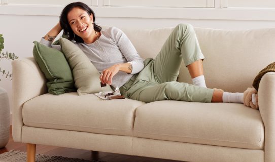 A woman relaxes on a Koala sofa, one of the best sofas for a living room