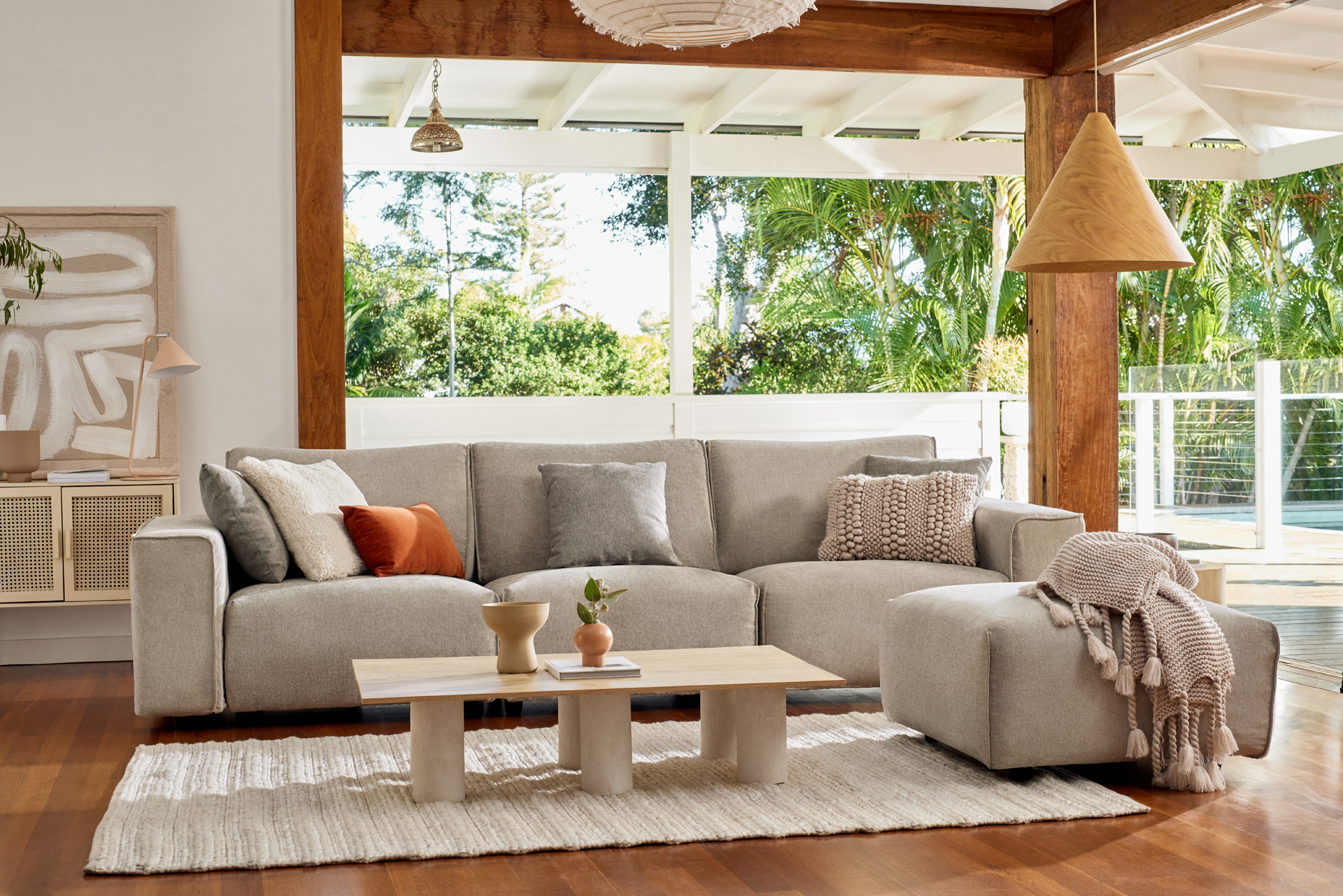 A beautiful Koala sofa in an airy living room with an outlook to the pool and garden