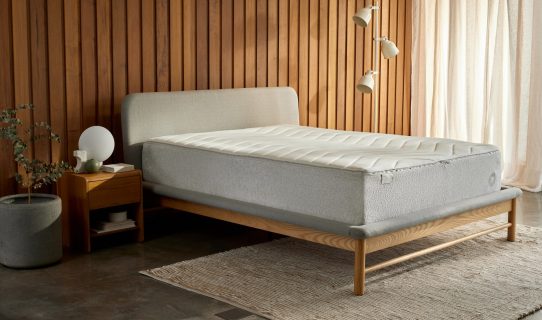 a Koala mattress on a Koala bed frame in a beautiful bedroom with a hard floor and panelled timber wall