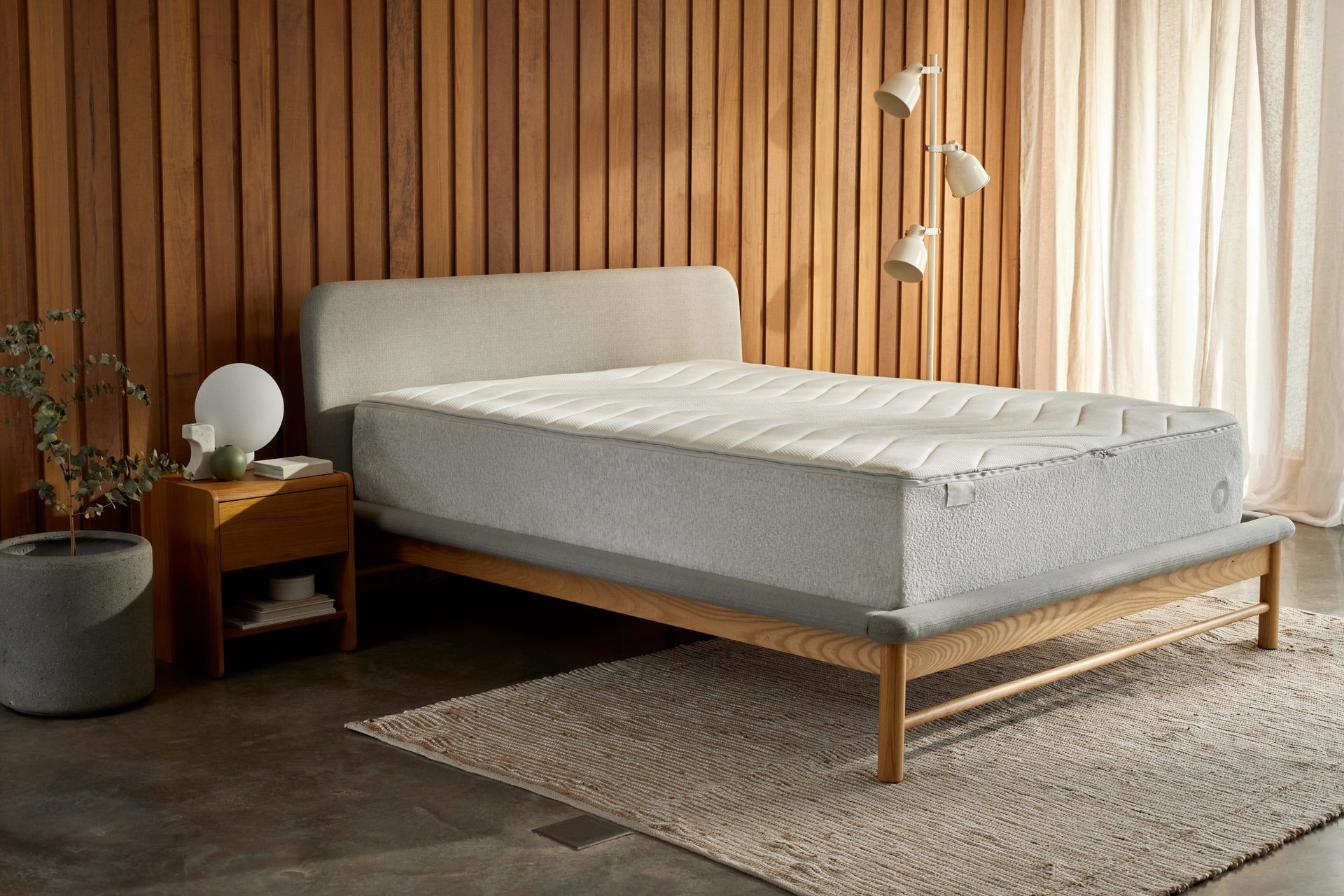 a Koala mattress on a Koala bed frame in a beautiful bedroom with a hard floor and panelled timber wall