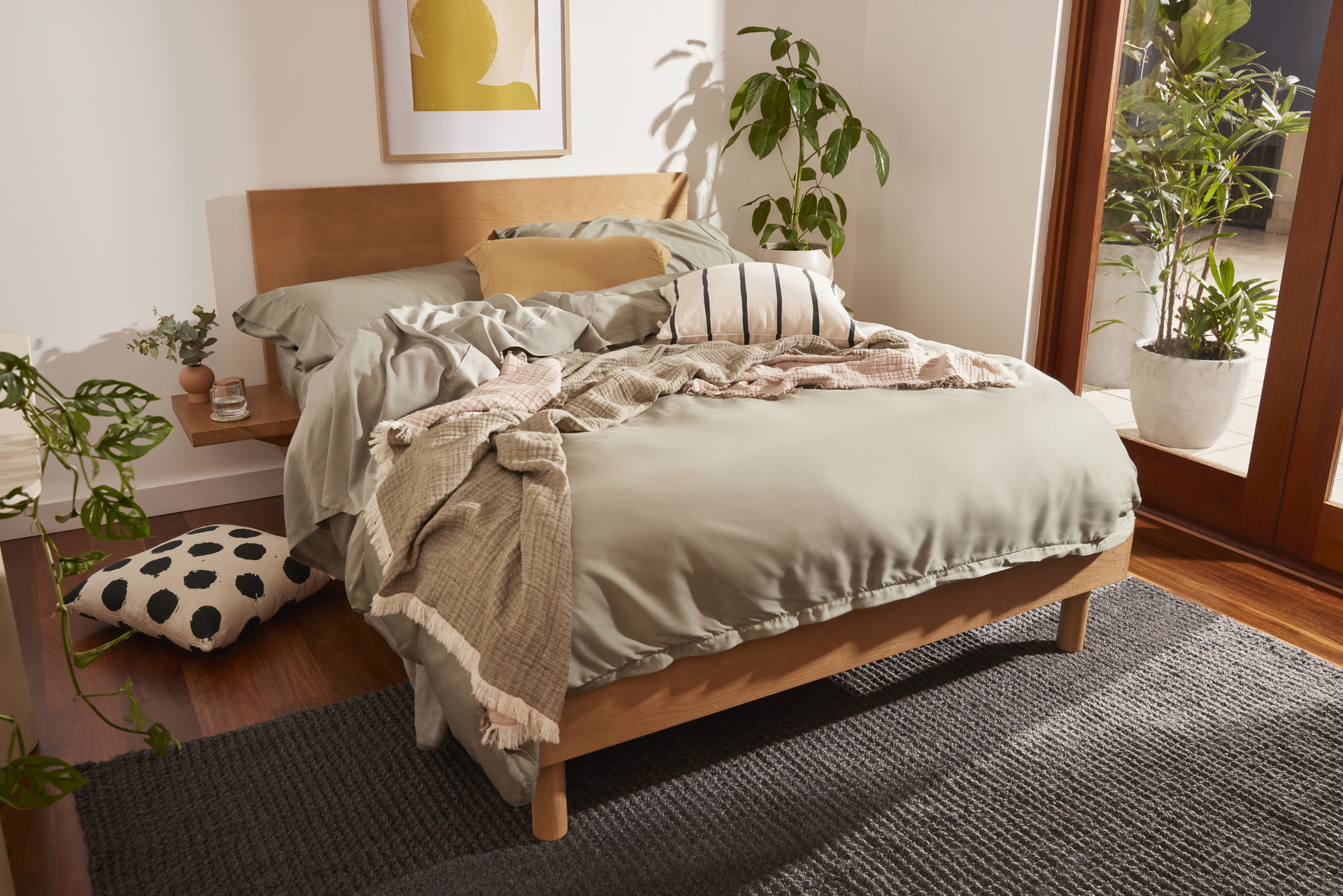 A double Koala bed and mattress in a teenage bedroom with bedding, throw and cushions