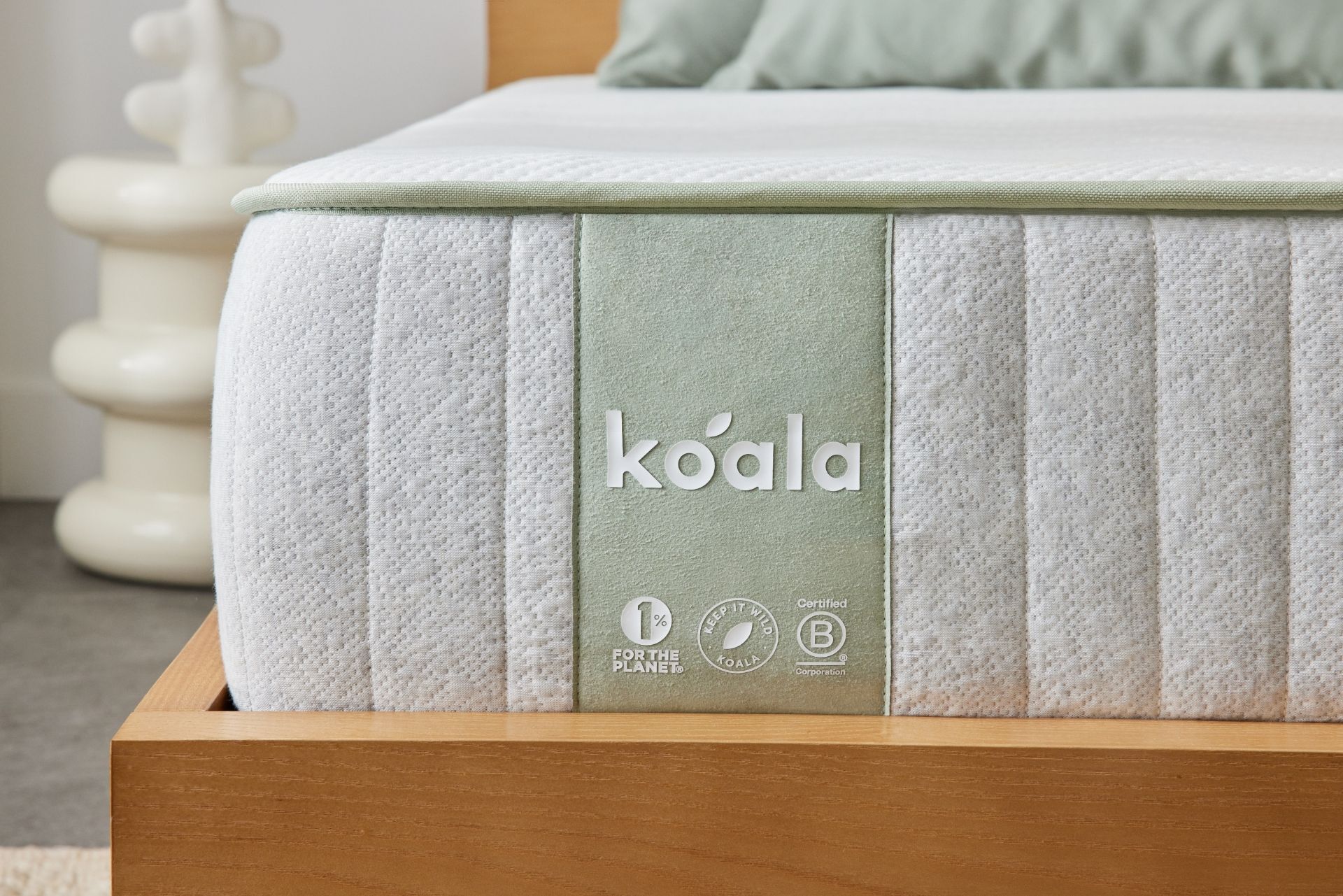The Koala SE Mattress sits on a bed frame.